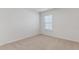 Neutral carpeted bedroom with a window and a clean, minimalist design at 879 Forth Ct, Gibsonville, NC 27249