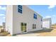 View of the side of the home with light vinyl siding, patio, and a sliding glass door at 879 Forth Ct, Gibsonville, NC 27249