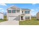 Beautiful home with white siding, black shutters, attached garage, and a well manicured lawn at 879 Forth Ct, Gibsonville, NC 27249