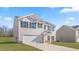 Charming two-story home featuring white siding, black shutters, and an attached two-car garage at 879 Forth Ct, Gibsonville, NC 27249