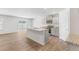 Kitchen with stainless steel appliances, gray cabinets, white granite countertops, and a kitchen island at 879 Forth Ct, Gibsonville, NC 27249