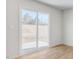 Bright living room featuring sliding glass doors leading to a patio and outside views at 879 Forth Ct, Gibsonville, NC 27249
