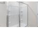 Modern shower with glass doors and built-in shelves for convenient storage at 879 Forth Ct, Gibsonville, NC 27249