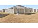 Exterior view of the home's backyard, showcasing the patio and siding at 880 Forth Ct, Gibsonville, NC 27249