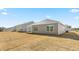 View of the back of the home with tan vinyl siding, showing the exterior and backyard at 880 Forth Ct, Gibsonville, NC 27249