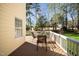 Relaxing outdoor dining on the deck, with serene views of the lush, green backyard at 9344 Palm Bay Cir, Raleigh, NC 27617