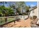 Inviting back deck with white railing and outdoor furniture, overlooking landscaped backyard and golf course at 9344 Palm Bay Cir, Raleigh, NC 27617