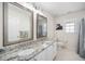 Bright bathroom featuring dual sinks, granite countertops, and neutral wall paint at 9344 Palm Bay Cir, Raleigh, NC 27617