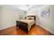 Comfortable bedroom featuring wood floors, neutral walls, and ample natural light at 9344 Palm Bay Cir, Raleigh, NC 27617