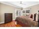 Cozy bedroom with hardwood floors, a dresser, and a window, offering a relaxing space at 9344 Palm Bay Cir, Raleigh, NC 27617