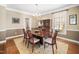 Elegant dining room with hardwood floors, chandelier, and large window for natural light at 9344 Palm Bay Cir, Raleigh, NC 27617