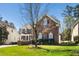 Lovely two-story brick home boasts beautiful landscaping and a classic architectural design at 9344 Palm Bay Cir, Raleigh, NC 27617