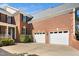 Charming brick home with an attached two-car garage and mature landscaping at 9344 Palm Bay Cir, Raleigh, NC 27617