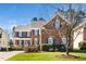 Charming two-story brick home with blue shutters, well-manicured lawn, and inviting front porch at 9344 Palm Bay Cir, Raleigh, NC 27617