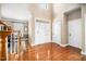 Bright foyer features hardwood floors, tall ceilings, and a staircase with wood banister at 9344 Palm Bay Cir, Raleigh, NC 27617