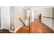 Upstairs hallway featuring hardwood floors and decorative lighting at 9344 Palm Bay Cir, Raleigh, NC 27617