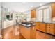Bright, well-appointed kitchen with a central island cooktop and an adjacent dining area at 9344 Palm Bay Cir, Raleigh, NC 27617
