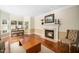 Bright living room showcasing a fireplace with a marble surround and gleaming hardwood floors at 9344 Palm Bay Cir, Raleigh, NC 27617