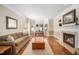 Spacious living room featuring hardwood floors, a fireplace, and large windows for ample light at 9344 Palm Bay Cir, Raleigh, NC 27617