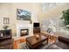 Bright living room featuring a fireplace, hardwood floors, and large windows at 9344 Palm Bay Cir, Raleigh, NC 27617