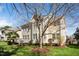 Back of house featuring a well-maintained lawn, mature tree, and spacious back deck at 9344 Palm Bay Cir, Raleigh, NC 27617