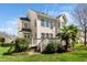 Stately rear of the home with a deck, multiple windows, and lush landscaping at 9344 Palm Bay Cir, Raleigh, NC 27617