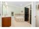 Bathroom featuring dual sinks, tiled shower and a soaking tub with tile surround at 101 N Bloodworth St, Raleigh, NC 27601