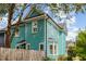Side view of a two-story home with white-trimmed windows and wooden fence at 101 N Bloodworth St, Raleigh, NC 27601