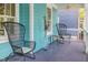 Covered front porch with comfortable seating, and decorative blue exterior at 101 N Bloodworth St, Raleigh, NC 27601