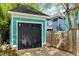 Detached garage with a black door and nearby wooden fence in the backyard at 101 N Bloodworth St, Raleigh, NC 27601