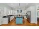 Stylish kitchen featuring white cabinets, stainless steel appliances, granite countertops and an island with light blue cabinetry at 101 N Bloodworth St, Raleigh, NC 27601