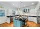 Bright kitchen boasts white cabinets, stainless steel appliances, granite countertops and an island with seating at 101 N Bloodworth St, Raleigh, NC 27601