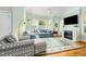 Comfortable living room with bay windows, a fireplace with stone surround and neutral decor at 101 N Bloodworth St, Raleigh, NC 27601