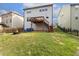 Back exterior of a two-story home with deck, patio, fenced yard, and fire pit area at 1033 Leatherstone Ln, Fuquay Varina, NC 27526