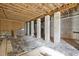 Unfinished basement with block walls and exposed wood ceiling, ready for customization and extra storage space at 1033 Leatherstone Ln, Fuquay Varina, NC 27526