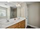 Bathroom boasting dual sinks, vanity with wood cabinets, and shower at 1033 Leatherstone Ln, Fuquay Varina, NC 27526