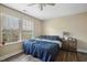 Bright bedroom boasts a large window, ceiling fan, and wood-look flooring at 1033 Leatherstone Ln, Fuquay Varina, NC 27526