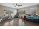 Large bedroom with many large windows, wood-look flooring, and a ceiling fan at 1033 Leatherstone Ln, Fuquay Varina, NC 27526