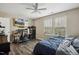 This comfortable bedroom features a ceiling fan and a large window at 1033 Leatherstone Ln, Fuquay Varina, NC 27526
