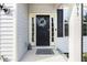Close-up of a charming front door with a decorative wreath and sidelights, adding a touch of elegance to the home at 1033 Leatherstone Ln, Fuquay Varina, NC 27526