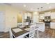 Eat-in kitchen features an island, stainless steel appliances, and white cabinetry at 1033 Leatherstone Ln, Fuquay Varina, NC 27526