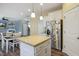 Open-concept kitchen with island, white cabinets and stainless steel refrigerator open to dining area at 1033 Leatherstone Ln, Fuquay Varina, NC 27526