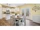 Eat-in kitchen with white cabinets, granite countertops, stainless appliances, and access to back deck at 1033 Leatherstone Ln, Fuquay Varina, NC 27526