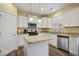 Well-equipped kitchen features granite countertops, stainless steel appliances, and white cabinetry at 1033 Leatherstone Ln, Fuquay Varina, NC 27526
