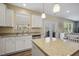 Well-lit kitchen showcasing stainless steel sink and appliances and a granite topped island at 1033 Leatherstone Ln, Fuquay Varina, NC 27526