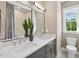 Modern bathroom with double sinks, sleek countertops, large mirror, and shower with decorative curtain at 1035 Zelkova Ln, Chapel Hill, NC 27517