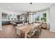 Spacious dining area next to the open kitchen, featuring modern lighting and a long dining table for gatherings at 1035 Zelkova Ln, Chapel Hill, NC 27517