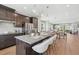 Open-concept kitchen featuring a large island with seating, stainless steel appliances, and hardwood floors at 1035 Zelkova Ln, Chapel Hill, NC 27517