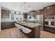 Modern kitchen featuring dark cabinetry, a large island with seating, and stainless steel appliances at 1035 Zelkova Ln, Chapel Hill, NC 27517