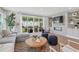 Cozy living room with a modern fireplace, built-in shelving, and a comfortable seating area overlooking the backyard at 1035 Zelkova Ln, Chapel Hill, NC 27517